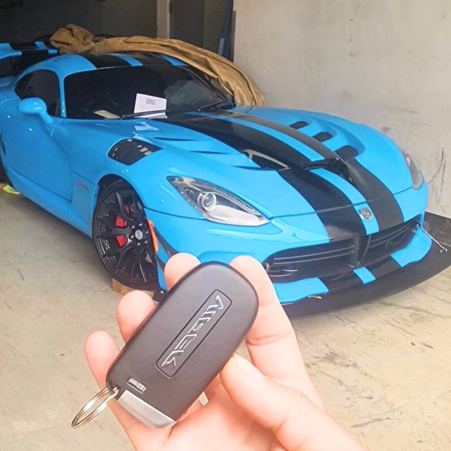 Auto locksmith cutting a replacement car key